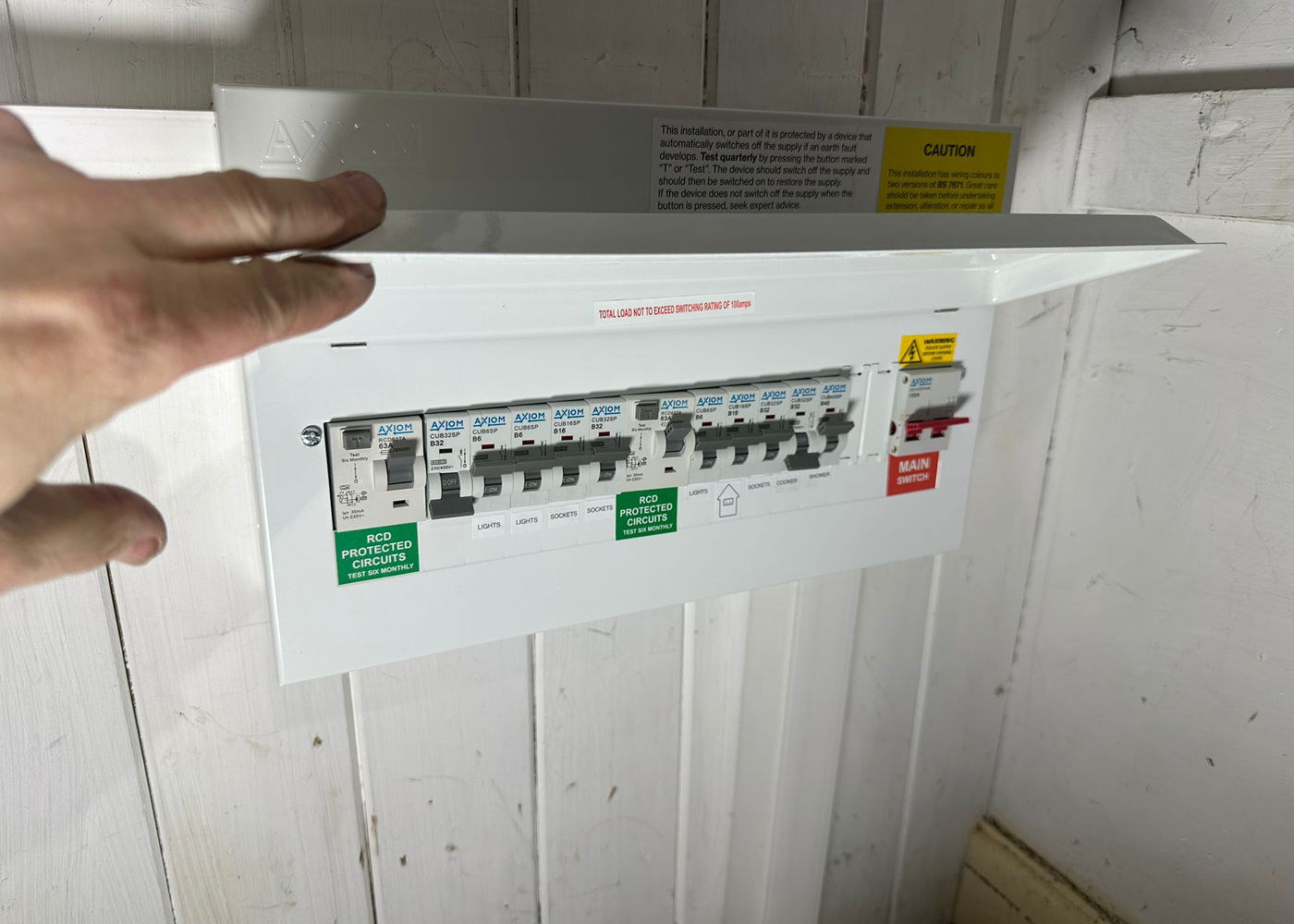 Electrician opening a consumer unit to check the RCD-protected circuits